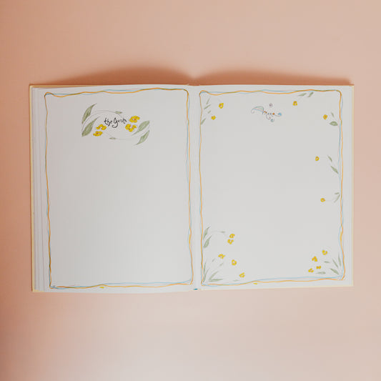 Open book with floral illustrations on a pink background