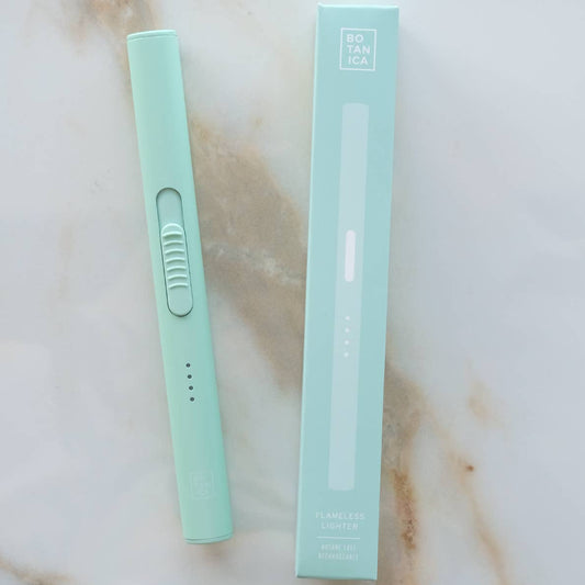 Mint green lighter with packaging on a marble surface