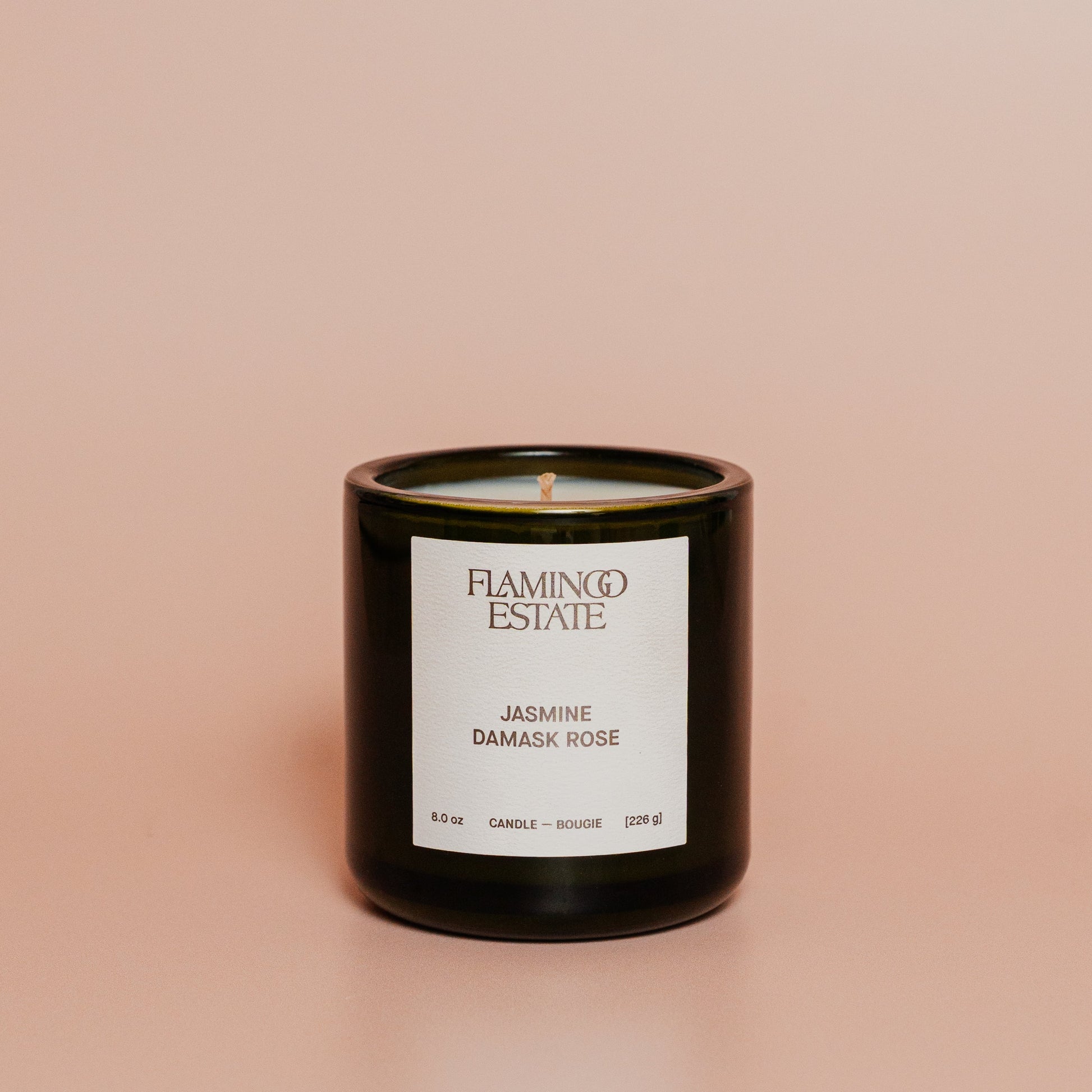 Flamingo Estate candle with jasmine damask rose fragrance on a beige background
