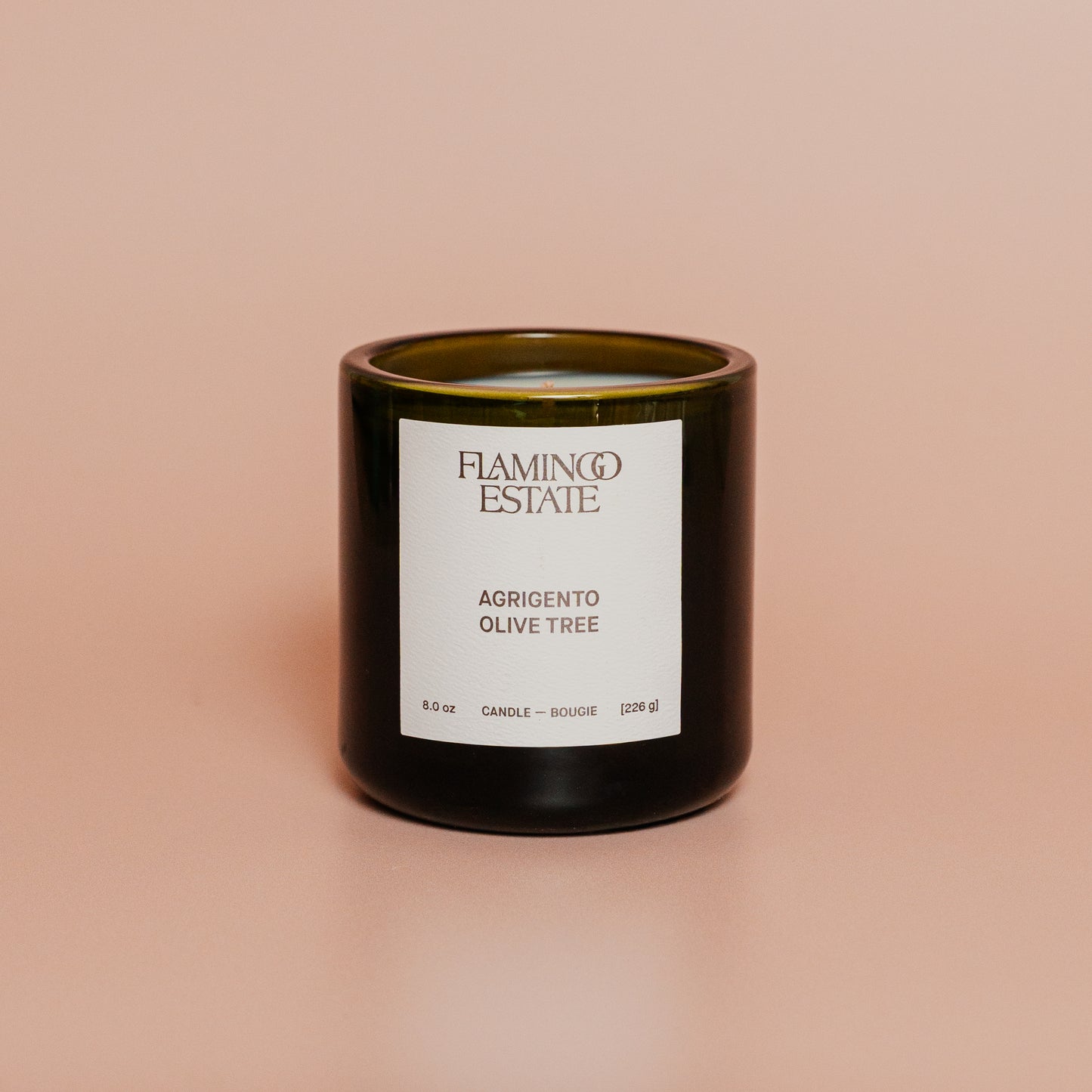Candle with a label on a beige background