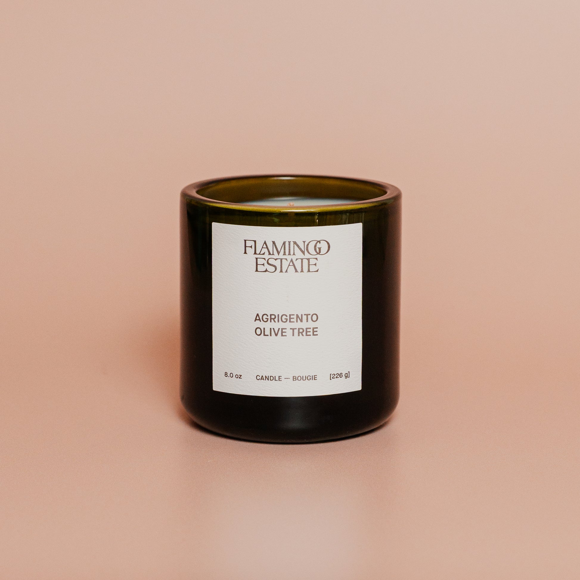 Candle with a label on a beige background