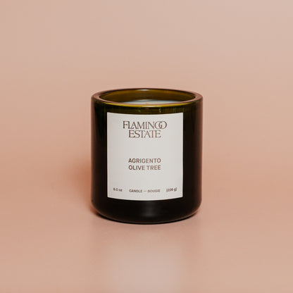 Candle with a label on a beige background
