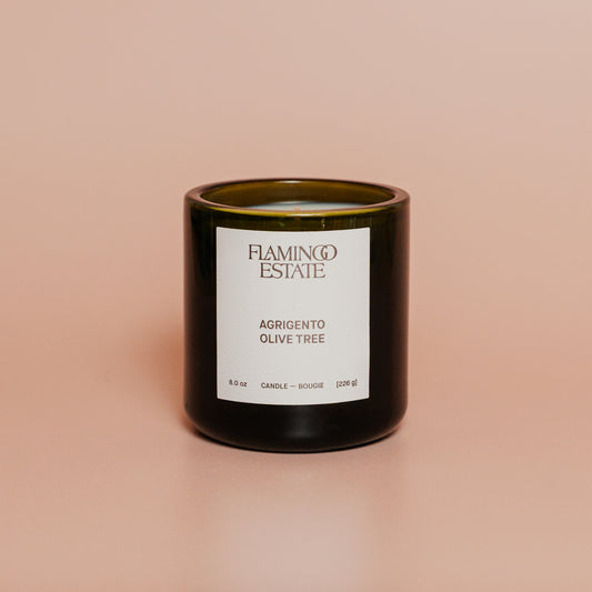 Candle with a label on a beige background