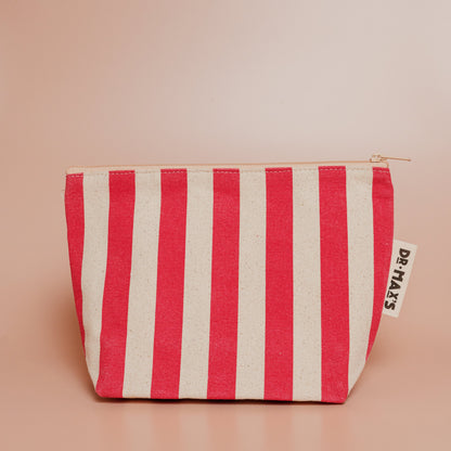 Red and white striped pouch with a brand label on a beige background