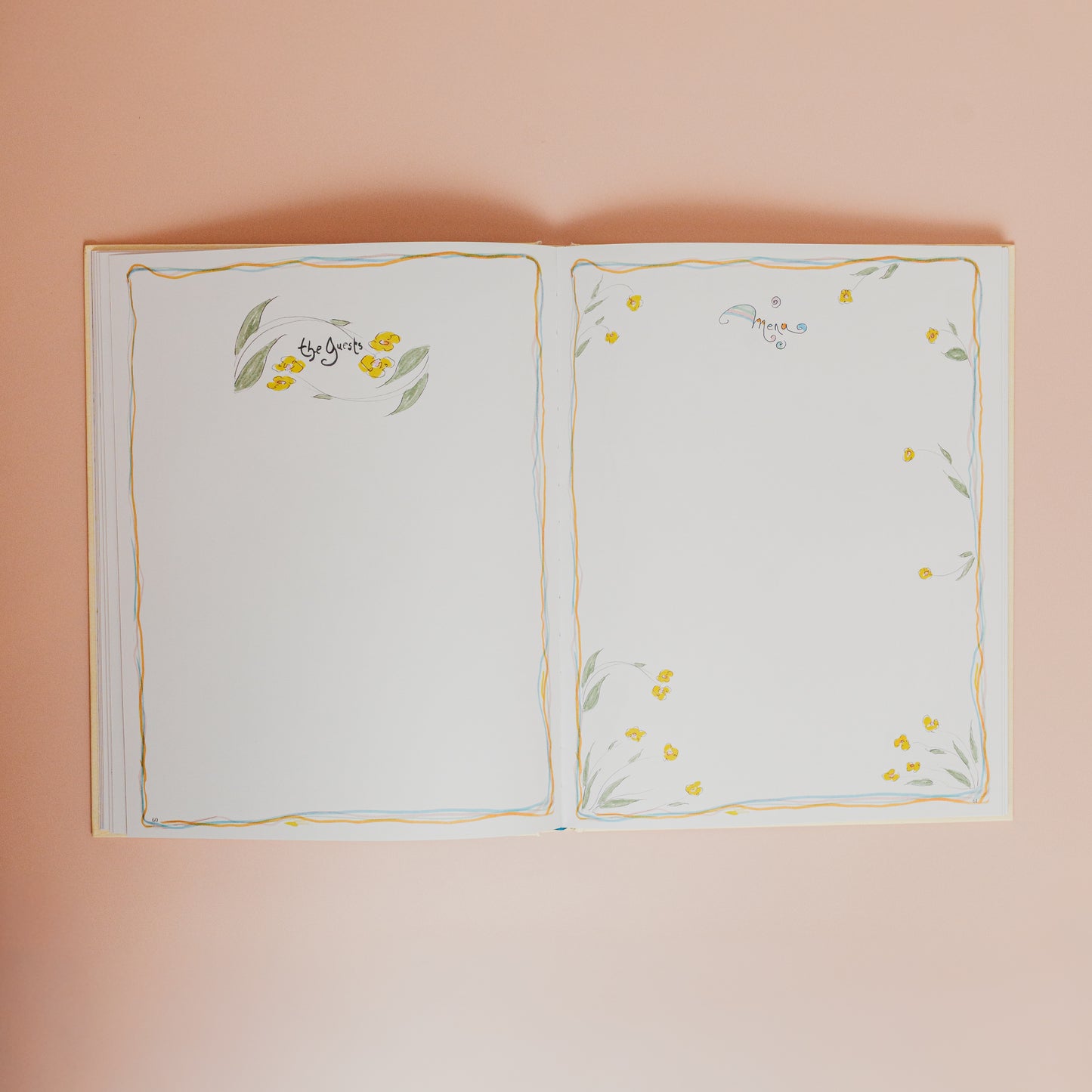Open book with floral illustrations on a pink background