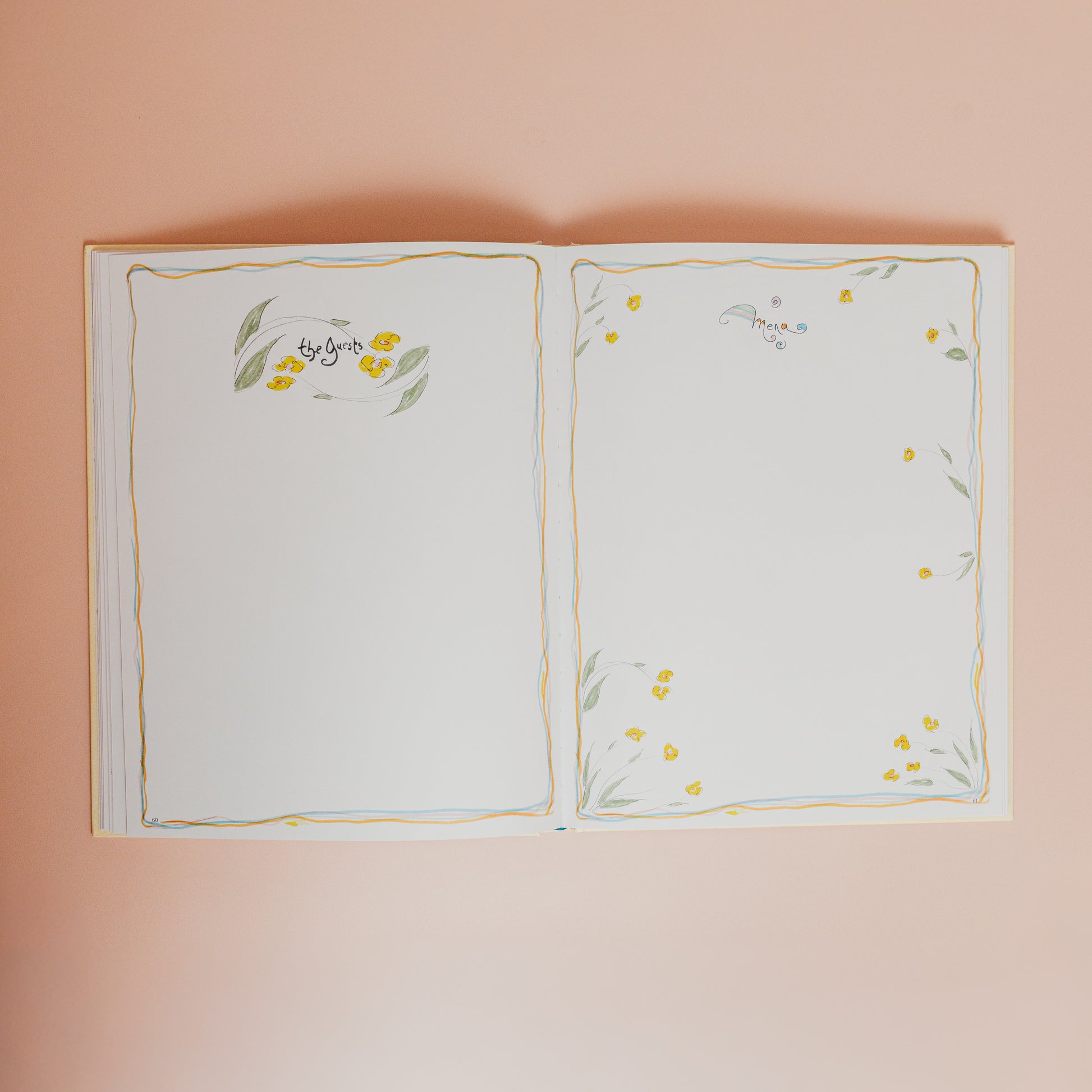 Open book with floral illustrations on a pink background
