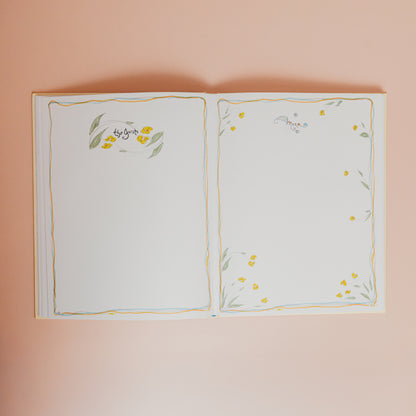 Open book with floral illustrations on a pink background