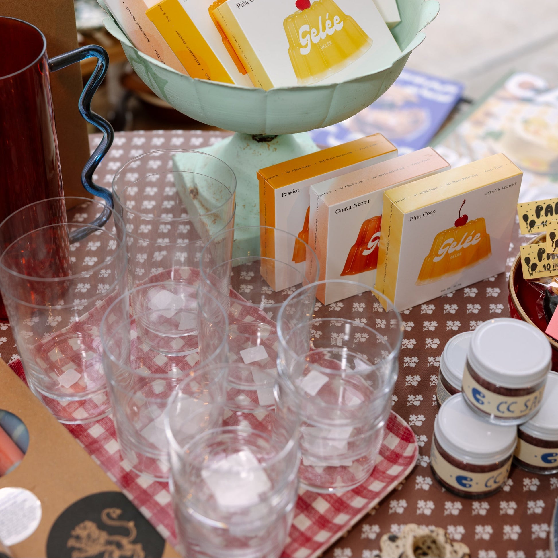 Tea bags and small containers on a checkered tablecloth with a blurred background