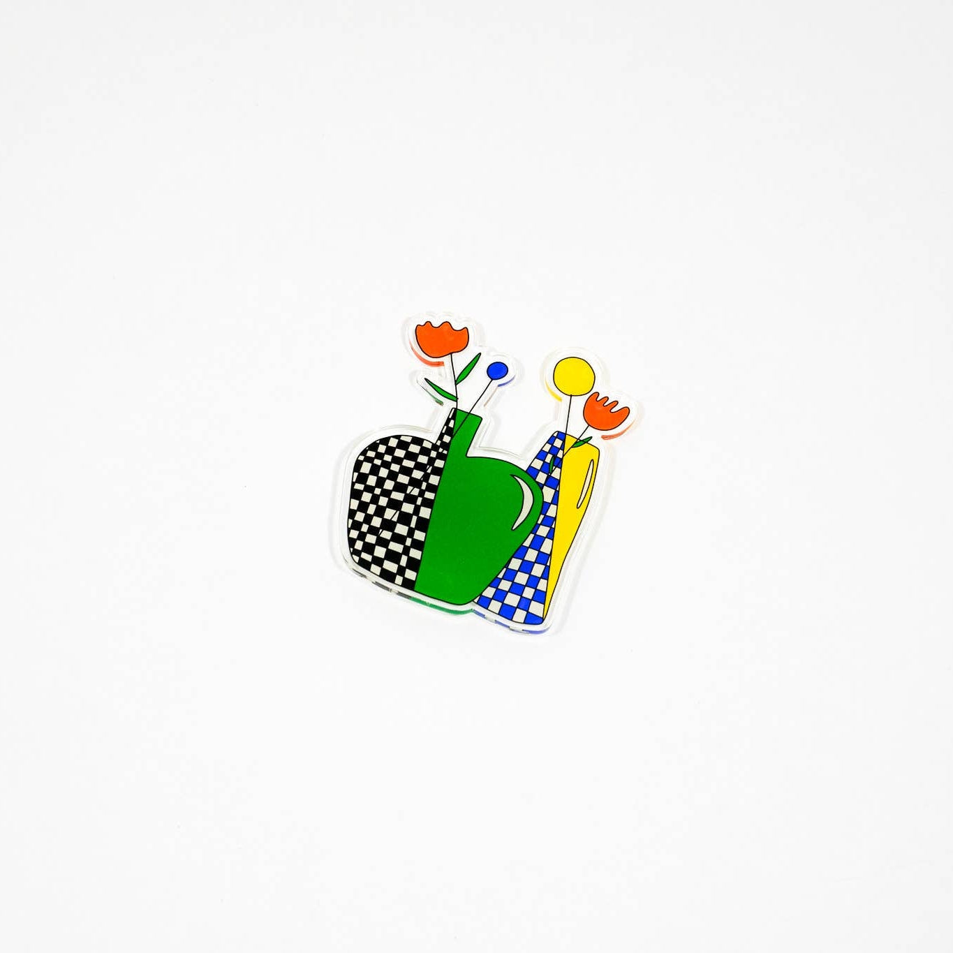 Decorative design with a checkered heart, green watering can, and flowers on a white background