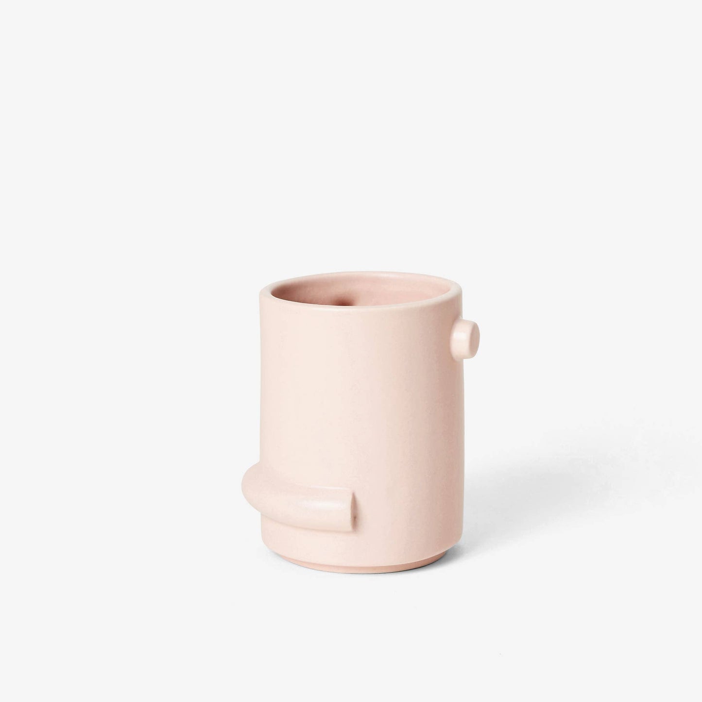 Pink ceramic cup on a white background