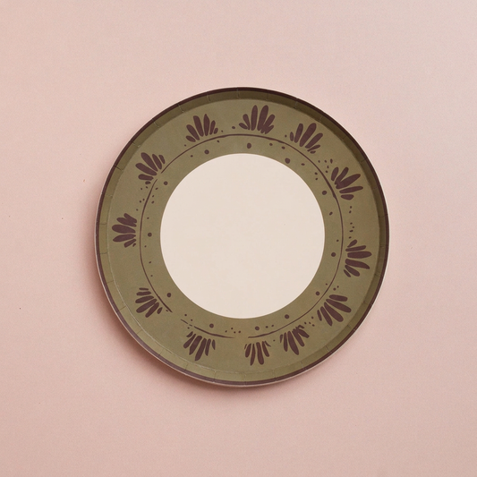 Unwrapped Fleur hors d'oeuvres paper plates with green patterned rim and flat cream center on a blush background