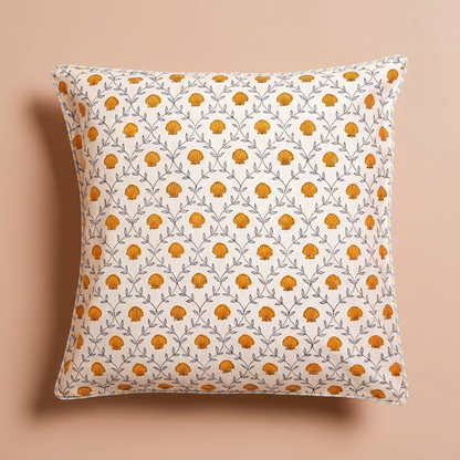 Seashell blockprint pillow cover with orange shells on a blush-peach background