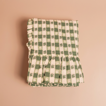 Virginia Stripe green gingham tablecloth folded detail on the standard blush-peach background